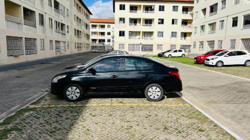 un pequeño coche negro aparcado en un estacionamiento en Apartamento Home Practice Flat, en São Luís