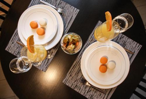 two plates of eggs and drinks on a table at Loft apartment in Druskininkai