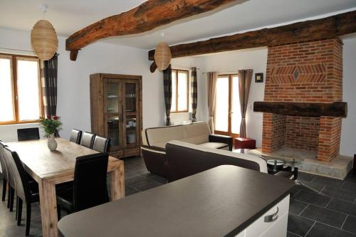 un salon avec un canapé et une table dans l'établissement demeure de caractère avec cheminée, à Houdetot