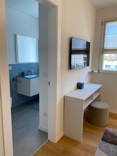 a bathroom with a white desk and a mirror at HZ+ Costantini in Pordenone