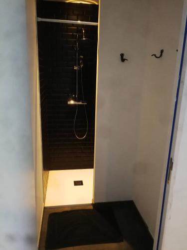 a bathroom with a shower with a bench in it at O'Parc du Louet in Mûrs-Érigné