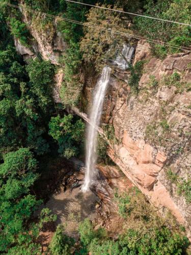 an aerial view of a waterfall on the side of a mountain at Salto Suizo Parque Ecologico in Independencia