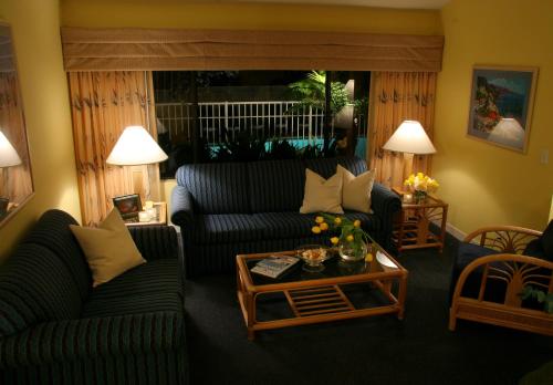 a living room with two couches and a coffee table at Aquamarine Villas in Oceanside