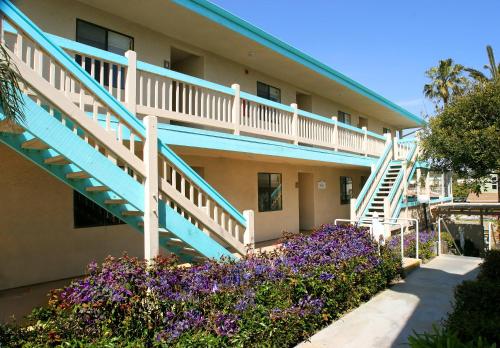 a building with blue stairs and purple flowers at Aquamarine Villas in Oceanside