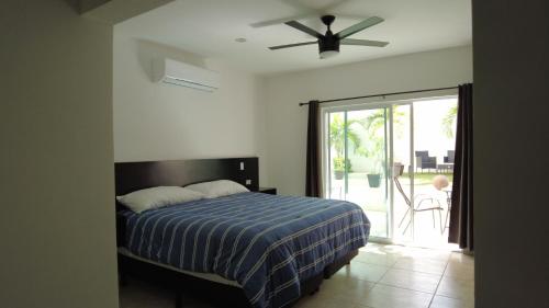 a bedroom with a bed and a ceiling fan at Suites Casa Blanca in La Paz