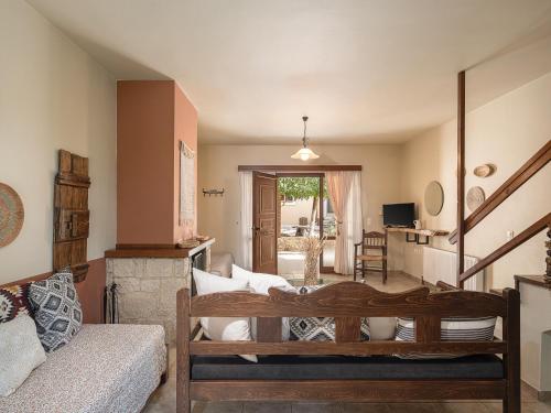 a living room with a couch and a staircase at Earino in Kato Asites
