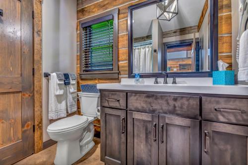 a bathroom with a toilet and a sink at Rustic Hideaway sleeps 4 Hot tub in De Soto