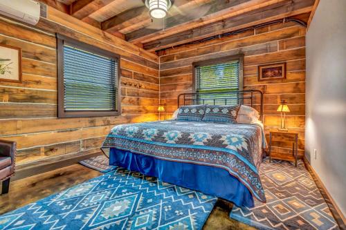 a bedroom with a bed in a log cabin at Rustic Hideaway sleeps 4 Hot tub in De Soto