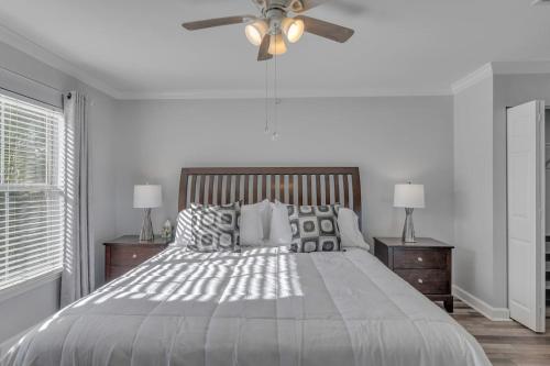 a bedroom with a bed and a ceiling fan at Modern Escape Cali King Beds EV Chargers Available in Lutz