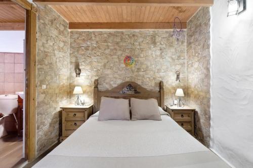 a bedroom with a large bed with two night stands at Apartamentos Trebol in Mocanal