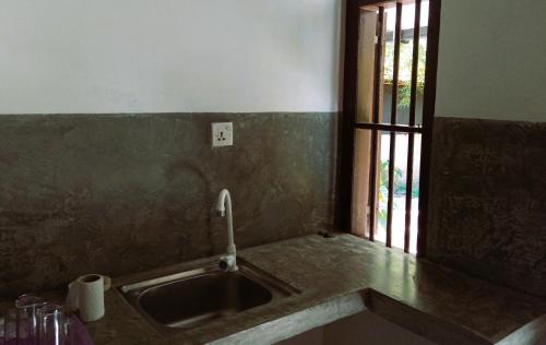 a kitchen with a sink and a window at AB Nest Hiriketiya in Dickwella