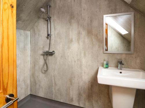 a bathroom with a sink and a shower at Kerrowdown Mill in Inverness