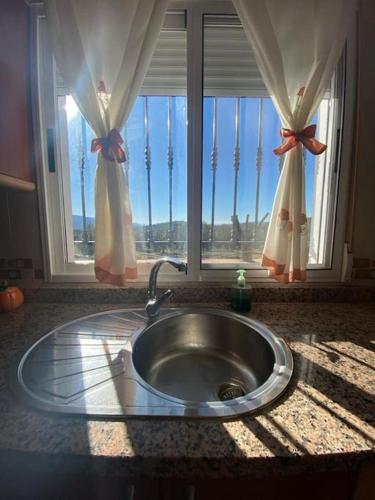 a kitchen sink in front of a window at Casa Sierra in La Puerta de Segura