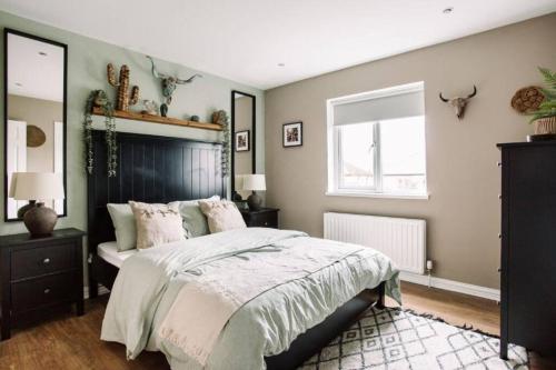 a bedroom with a large bed and a window at Modern & Stylish Home in the Heart of Belfast in Belfast