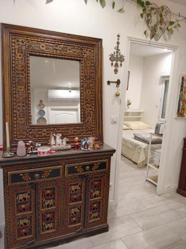 a room with a dresser with a mirror on it at FRANCIS Xavier in Villeneuve-le-Roi