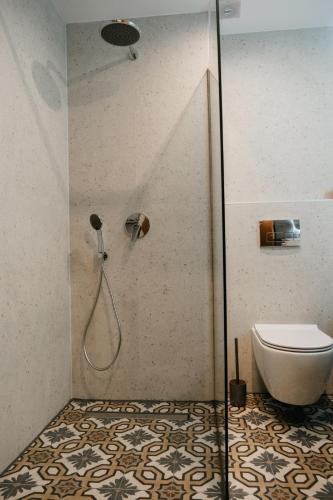 a bathroom with a shower with a toilet in it at Urban Style Suite in Alexandroupoli