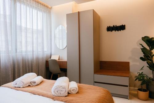 ein Schlafzimmer mit einem Bett mit Handtüchern darauf in der Unterkunft Urban Style Suite in Alexandroupoli
