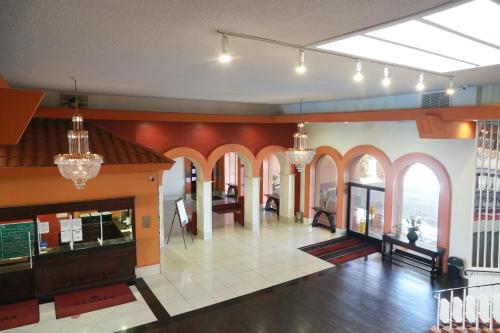 a large room with arched windows and a lobby at Ramada by Wyndham Fresno North in Fresno