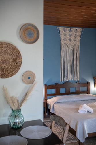 a bedroom with a bed and a table with a vase at Earino in Kato Asites