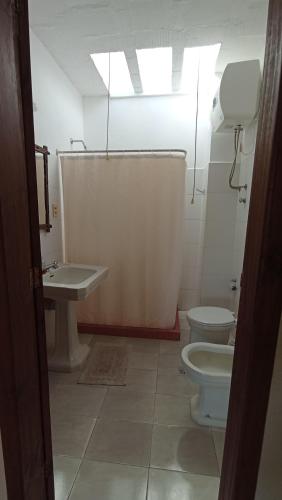 a bathroom with a toilet and a sink at Casa Timbó in Piriápolis