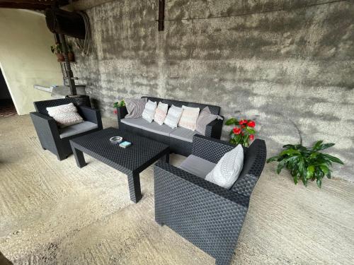 a group of couches and tables in a room at Casa da Grota in Porto Moniz