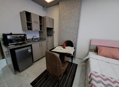 a small living room with a table and a kitchen at Juliana beach resort in el ahead st in El Gouna
