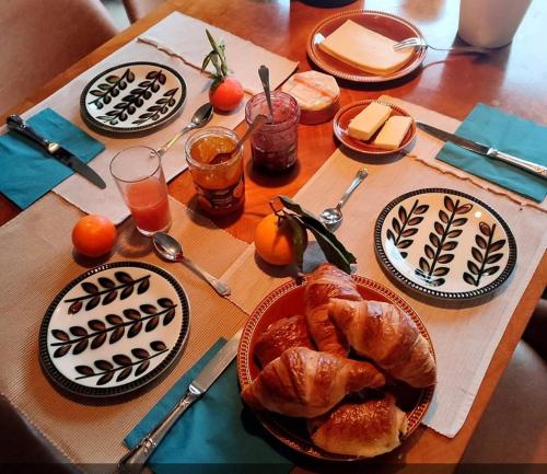 stół z talerzami jedzenia i rogalikami w obiekcie Fredhousedurbuy 1 w mieście Durbuy