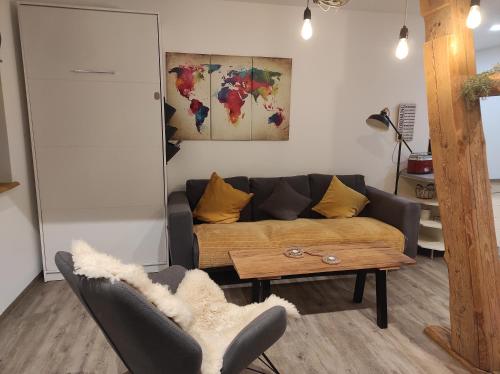 a living room with a couch and a table at Zum Scheunenhof - Scheune in Ichenhausen