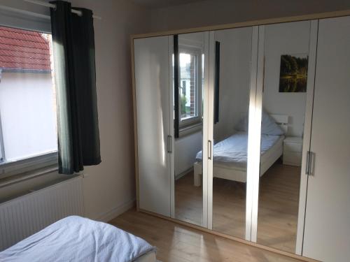 a mirror in a room with a bed and a bedroom at Ferienwohnung Wiebe in Minden