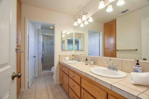 a bathroom with two sinks and a large mirror at Fallbrook, CA. Entire house. “Hilltop comforts”. in Fallbrook