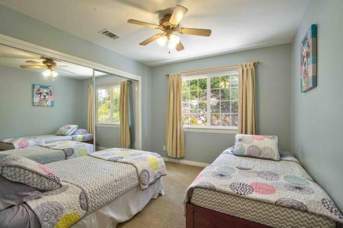 a bedroom with two beds and a ceiling fan at Fallbrook, CA. Entire house. “Hilltop comforts”. in Fallbrook