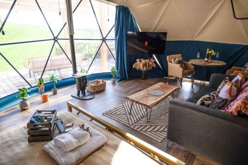 a room with a living room with a tent at Dalriada Den - Luxury GeoDome in Portpatrick