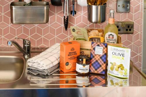 a counter with a sink with food and a bottle of wine at Dalriada Den - Luxury GeoDome in Portpatrick