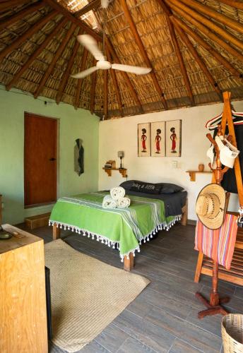 a bedroom with a bed and a ceiling fan at CASA AUM in Brisas de Zicatela