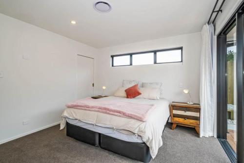 a bedroom with a large bed and a window at Elegant, Executive Retreat in Methven