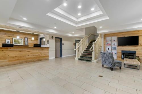 a large living room with a staircase and a chair at Country Inn & Suites by Radisson, Tampa Airport North, FL in Tampa