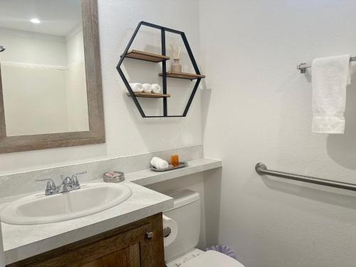 ein Badezimmer mit Waschbecken, Toilette und Spiegel in der Unterkunft Tiger's Trail RV Resort in Baton Rouge