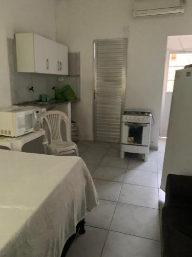 a kitchen with a table and a stove at Kitinete Aconchegante in Porto De Galinhas