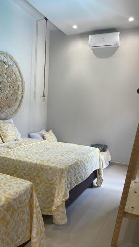 a hotel room with two beds and a heater at CASA TEMPORADA BARREIRINHAS Yellow 3 in Barreirinhas