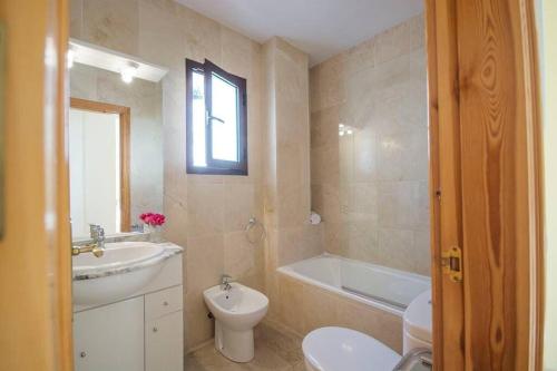 a bathroom with a sink and a toilet and a tub at Apartamento 33, Frigiliana Spacious family Apartment with large Pool in the town center HansOnHoliday Rentals in Frigiliana