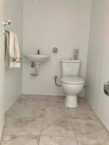 een badkamer met een toilet en een wastafel bij Sossego in Praia