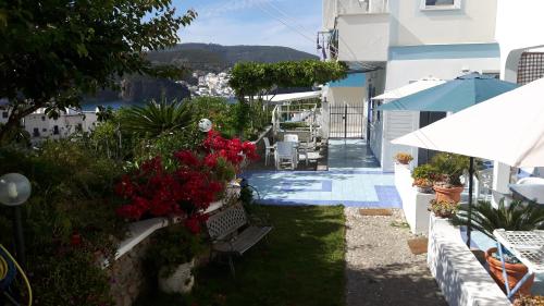 a view of a yard with benches and flowers at Casa Acqua Marina Ponza in Ponza