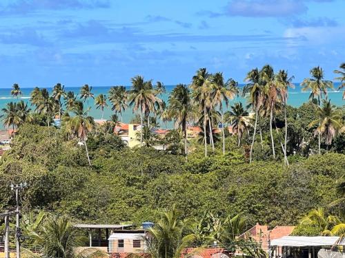 a view of the ocean and palm trees at Casa de Praia Maragoggi in Maragogi