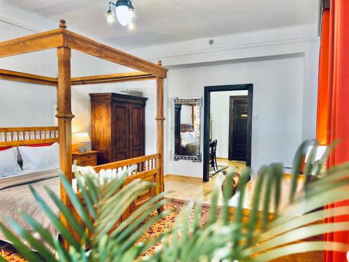 a bedroom with a wooden bed and a mirror at Zentrum Vintage Appartments in Braşov