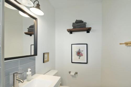 a bathroom with a sink and a mirror at Stroll to Main St: 2BR on the Park in Philadelphia