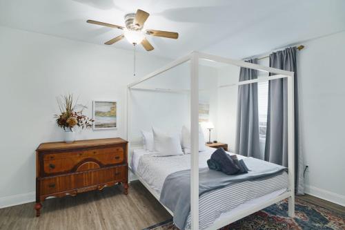 a bedroom with a canopy bed and a ceiling fan at Stroll to Main St: 2BR on the Park in Philadelphia