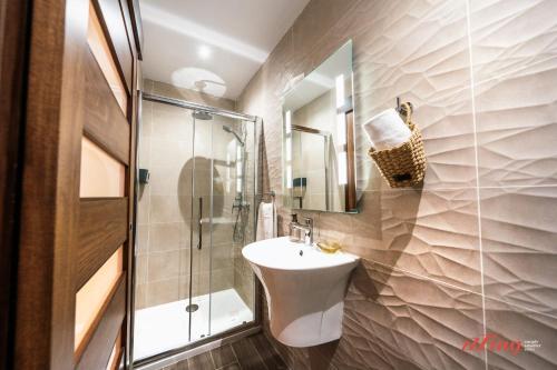 a bathroom with a sink and a shower at Sea Views in a Stunning 2BR Apartment in St Paul's Bay in St. Paul's Bay