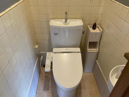 a bathroom with a white toilet and a sink at Mugi no Oyado "Mizube" - Vacation STAY 45537v in Kuwana