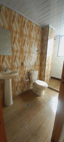 a bathroom with a toilet and a sink at Sofia in Oruro