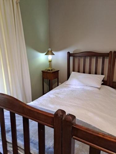a bedroom with a bed and a lamp on a table at Lynthorn Farm Cottage in Frere